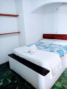 Ένα ή περισσότερα κρεβάτια σε δωμάτιο στο Pousada & Hostel Interligado Tiririca