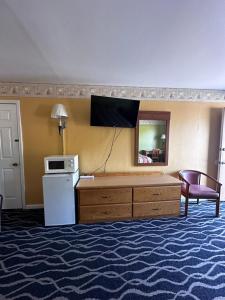 a hotel room with a tv on the wall at Park inn motel in Linton