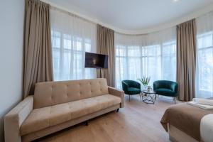 a living room with a couch and a bed at Hama Boutique Stays in Budapest