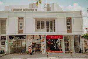 a store front of a white building with windows at Comfort in Valledupar