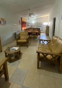 a living room with couches and chairs and a table at La Mericia in Villa Carlos Paz