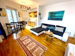 a living room with a couch and a table at KENT Apartments in Prishtinë