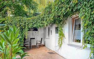 a white house with a window and a table and chairs at Ferienwohnung Waren Müritz in Waren +15 photos