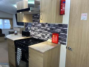a kitchen with a stove and a counter top at The Getaway Billing Aquadrome in Great Billing