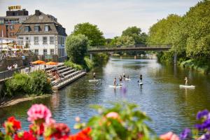 a group of people on paddle boards in a river at Apartmentzimmer KEINE MONTEURE in Rheine