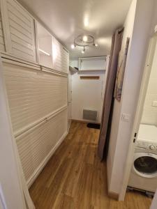 a closet with white doors and a wooden floor at Centre Station - La Vallée Blanche 2 - La Foux in Allos +22 photos
