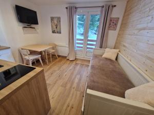 a living room with a couch and a table at Centre Station - La Vallée Blanche 2 - La Foux in Allos