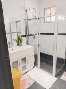 a bathroom with a shower and a sink at Survivour Home in Nadi