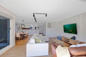 a living room with a couch and a table at Sandy Cove Apartment The Entrance 8 in The Entrance