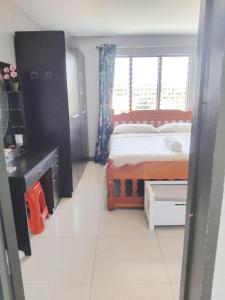 a bedroom with a bed and a fireplace and a window at Survivour Home in Nadi