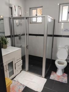 a bathroom with a shower and a toilet at Survivour Home in Nadi