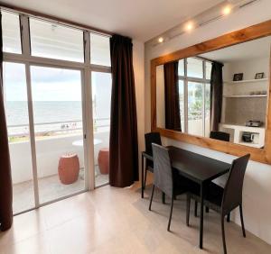 a dining room with a table and a view of the ocean at Beachfront Apartment with Two Queen Beds, Kitchen and Balcony in Boracay