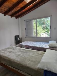 a bedroom with two beds and a window at valeriadelmar in Valeria del Mar