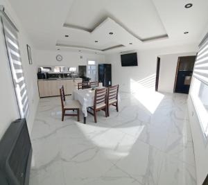 a kitchen and dining room with a table and chairs at Mate 1 in Río Gallegos
