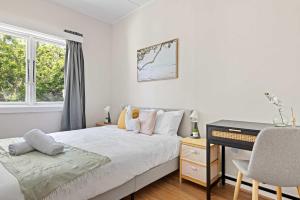 a bedroom with a bed with a desk and a keyboard at Rustic Queen Room in Glebe - Next to USYD - Shared Bathroom in Sydney