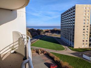 a balcony with a view of a building and the ocean at Lord Nelson 715 in Döse