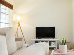 a living room with a tv and a couch at Lyons in Port Fairy