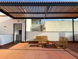a patio with two chairs and a table on a building at TH0 Luxury two bedrooms Apartments with High-Tech Amenities in Athens