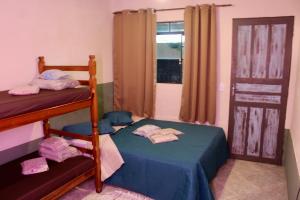 a bedroom with two bunk beds and a window at Pousada Caragua Poesia na Praia in Caraguatatuba +23 photos
