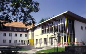 a large white building with a lot of windows at Jugendherberge Lübeck Vor dem Burgtor in Lübeck