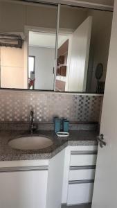 a bathroom counter with a sink and a mirror at VG Sun Cumbuco in Cumbuco +17 photos