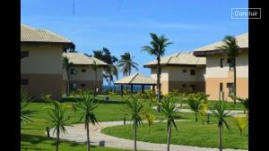a row of houses with palm trees in a park at VG Sun Cumbuco in Cumbuco