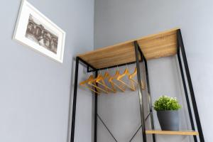 a closet with hangers and a potted plant at Elephant and Castle - Exclusive Holiday Home in Catania