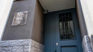 a blue door of a building with a sign next to it at Elephant and Castle - Exclusive Holiday Home in Catania