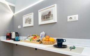 a white counter with a basket of fruit on it at Elephant and Castle - Exclusive Holiday Home in Catania