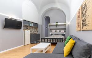 a living room with a couch and a bed at Elephant and Castle - Exclusive Holiday Home in Catania