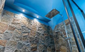 a bathroom with a shower with a blue ceiling at Elephant and Castle - Exclusive Holiday Home in Catania