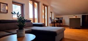 a living room with a couch and a table at Ferienwohnung SEElig in Fischbachau