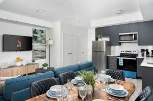 a kitchen and living room with a table and chairs at Sweet Townhouse with Rooftop Patio in Erin Mills in Mississauga