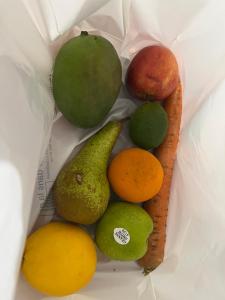 a group of fruits in a bag with a banana and an apple at Centre de bien-être LES FRAGRANCES in Morne-à-lʼEau