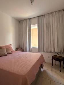 un dormitorio con una cama y una ventana en Casa Estrela Room, en Salvador