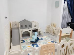 a childs room with a play set and toys at Melaka privatepool bungalow BBQWIFI krubong in Malacca