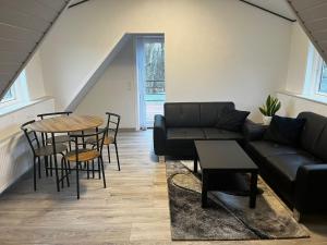 a living room with a couch and a table at Holiday Nest 1 in Sønderborg