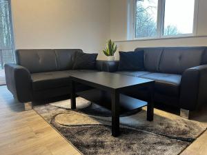a living room with a couch and a coffee table at Holiday Nest 1 in Sønderborg