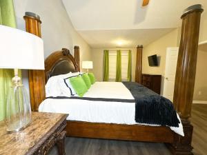 a bedroom with a large bed with green pillows at Cozy 3BR Home Near ATL Airport in Fairburn