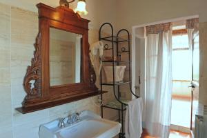 un bagno con lavandino e specchio di Agriturismo Podere Alberese ad Asciano