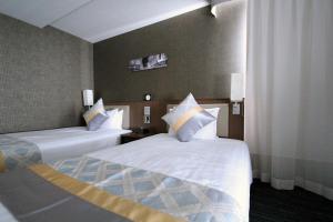 Postel nebo postele na pokoji v ubytování KOKO HOTEL Ginza-1chome