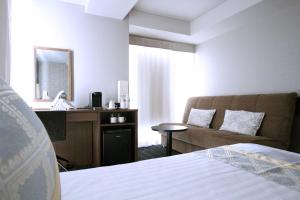 Postel nebo postele na pokoji v ubytování KOKO HOTEL Ginza-1chome