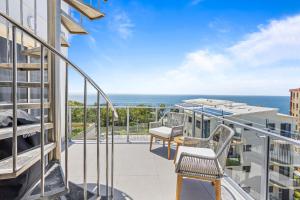 a balcony with a view of the ocean at Stylish 3-Bed Apartment in Coastal Redcliffe in Redcliffe