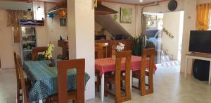 a kitchen and dining room with a table and chairs at Queenslander Hotel and Restaurant in Alaminos