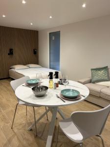 a dining room with a table and a bed at Studio chic et cocon proche de Disney in Lagny