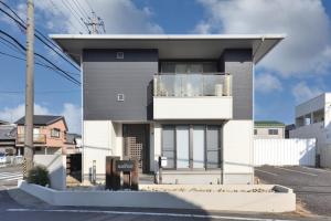 a modern house with a balcony on a street at Villa RIKUNOYA SUZUKA in Suzuka