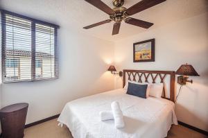 a bedroom with a bed with a ceiling fan at 9-26 Costa Linda Jacó Beach pool view Balcony in Jacó +12 photos
