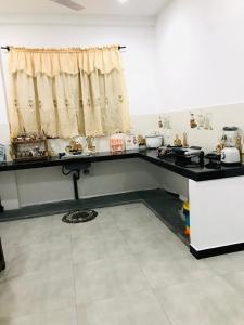 a kitchen with a black counter top and a window at River Beach View in Hikkaduwa +7 photos