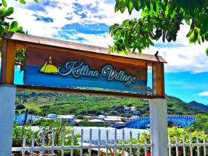a sign for keilina village with a view of the water at Ketlina Village in Providencia