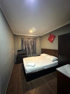 Postel nebo postele na pokoji v ubytování Li Garden Hotel
